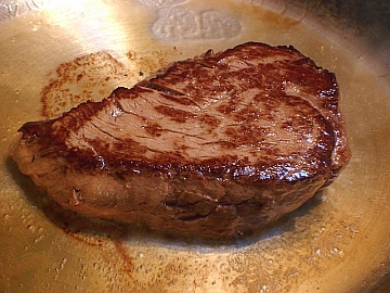 Browned steak ready for cooking.