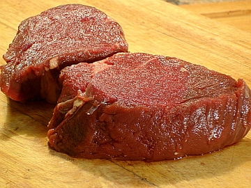Seasoned steak ready for cooking.